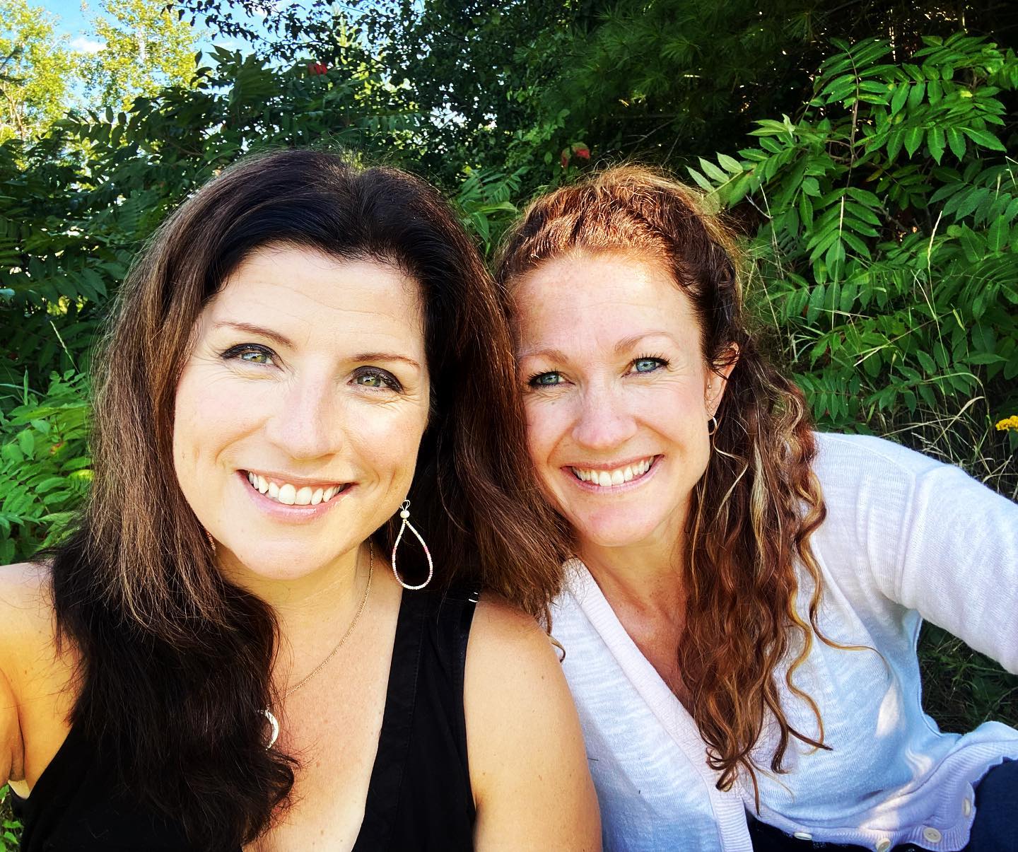 Two women smiling, happy to be having a meeting together after so much time alone.